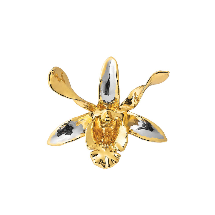 Gold orchid charm with black and white inlays and a central clear stone