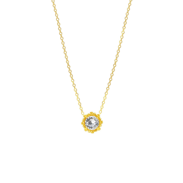 Risis Majestic Vanda Necklace With White Topaz - A golden necklace with a delicate chain holds a sparkling, round, clear gem encircled by intricate gold petals.