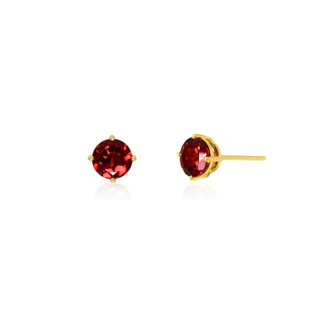 Risis Majestic Vanda Earrings With Red Garnet - A pair of round, brilliant red gemstone earrings set in a gold-tone mount, reflecting light with a shining effect, isolated on a clear background.