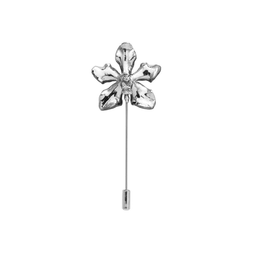 Risis Vanda Limbata Lapel Pin Pd - A silver lapel pin shaped like a flower with five petals and a central gem, exhibiting a polished and reflective surface.