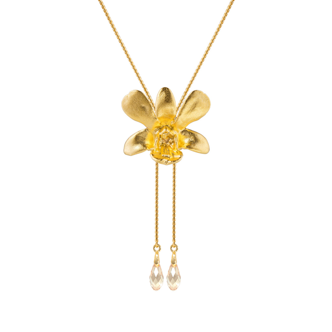 Risis Dendrobium Thong Chai Orchid Slider Necklace with Crystal Tailends (G) - A gold necklace with a matte flower pendant, centering a transparent yellow stone, and two clear teardrop crystals dangling below on delicate chains.