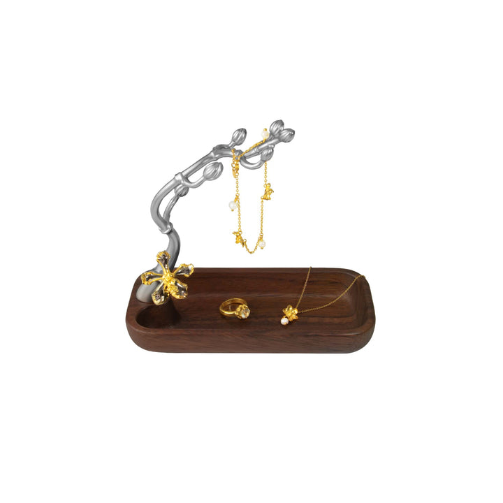 Risis Wee Kim Lian Groves Holder - A wooden jewelry tray holds gold-tone pieces with floral motifs; a matching metallic tree-like stand displays hanging earrings.