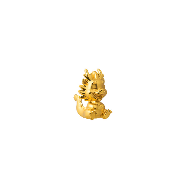 Gold-tone dragon figurine in side view, spiky mane and curved tail detail.