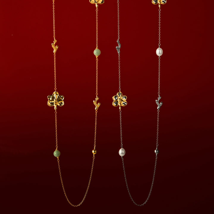 RISIS Blossom Long Necklace: Natural Ascocenda Orchids Encapsulated in 24K Swiss Gold and Palladium with Freshwater Pearls, and Encapsulated in 24K Swiss Gold with Type A Burmese Jadeite.