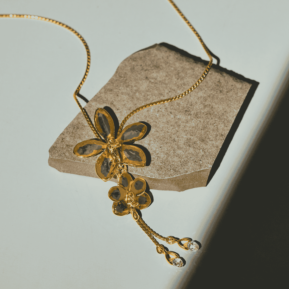 RISIS Dual Orchid Bloom Long Slider Necklace in 24K Gold & Palladium with Crystal Tailends