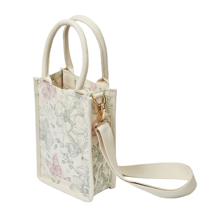 RISIS Orchid Canvas Mini Tote Bag. Designed for versatility, the bag comes with an optional strap, allowing for an effortless transition from handheld to crossbody wear.