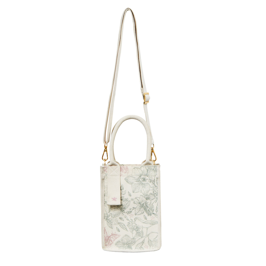 RISIS Orchid Canvas Mini Tote Bag. Designed for versatility, the bag comes with an optional strap, allowing for an effortless transition from handheld to crossbody wear.