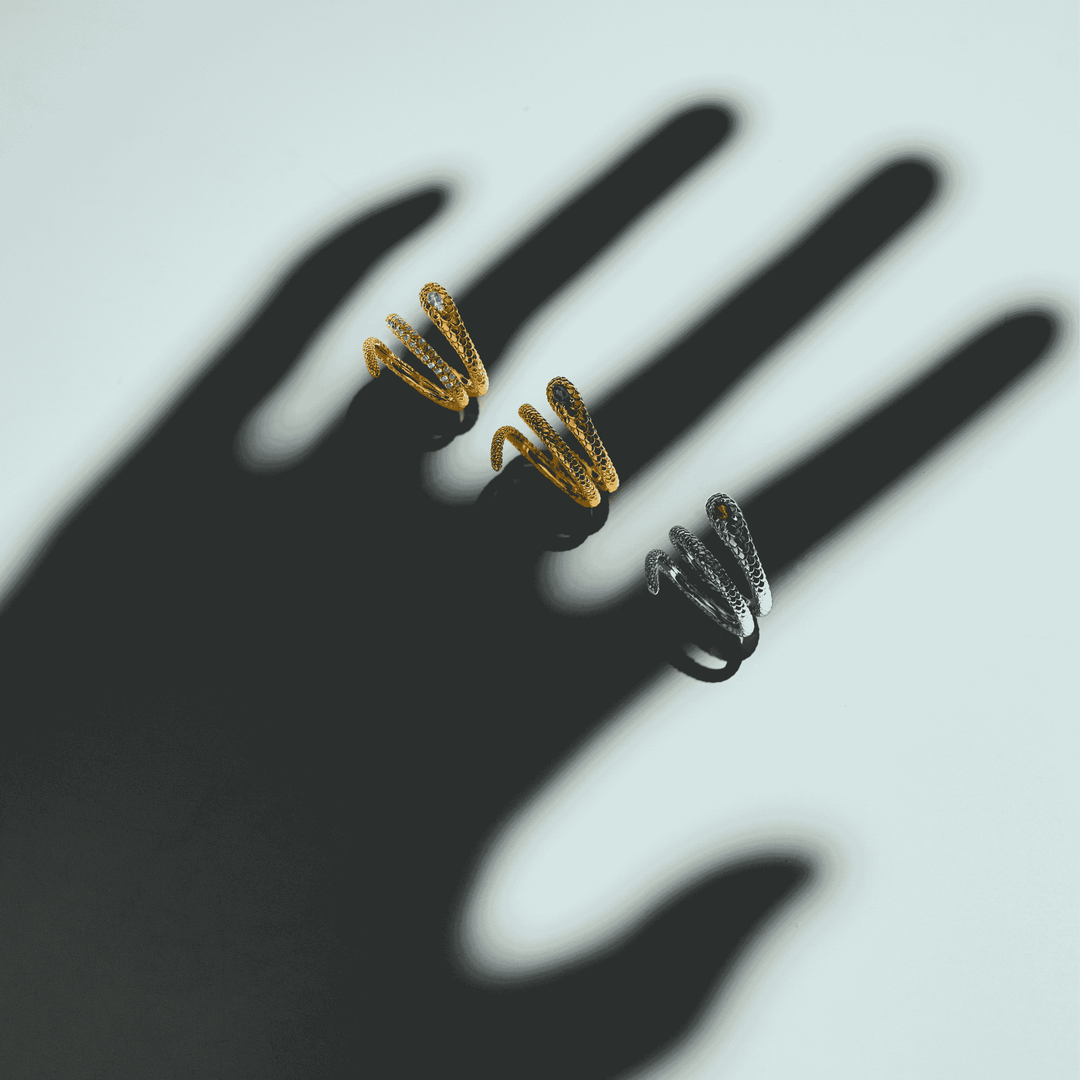 RISIS Serpentine Enigma Ring, 925 Sterling Silver encapsulated in Rhodium with Red Garnet, in 18K Gold with White Topaz, in 18K Gold with Chrome Diopside