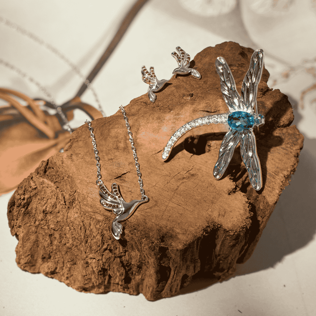 RISIS Wings of Botany Dragonfly Brooch in Rhodium with Topaz; Sunbird Whispers Earrings and Necklace in Rhodium with Red Garnet