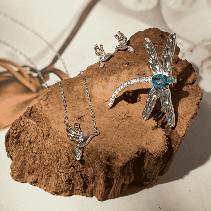 RISIS Wings of Botany Dragonfly Brooch in Rhodium with Topaz; Sunbird Whispers Earrings and Necklace in Rhodium with Red Garnet