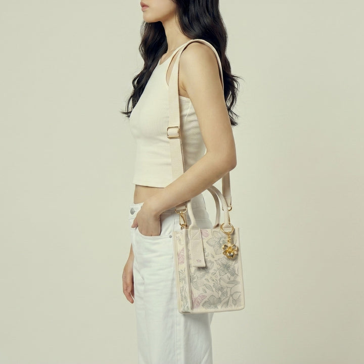 RISIS canvas orchid mini tote bag worn as a shoulder bag 
