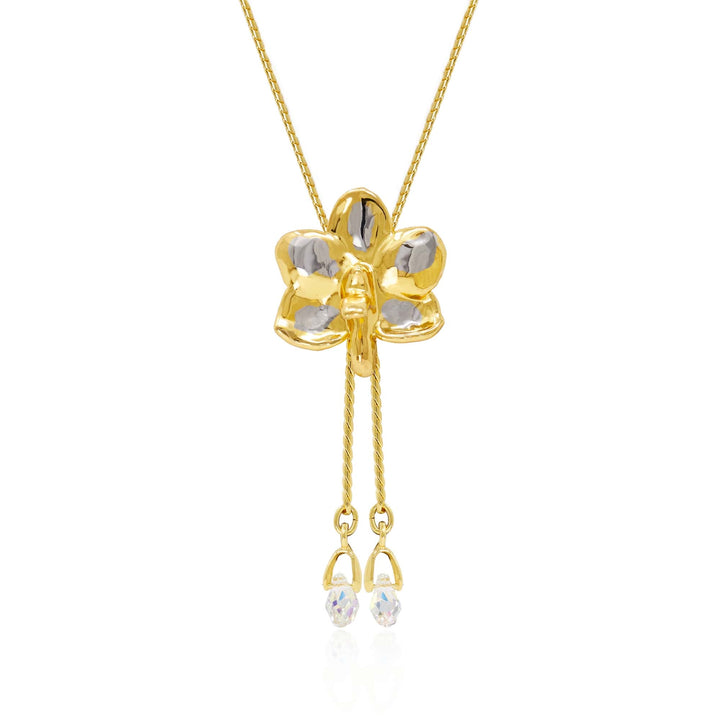 Risis Ascocenda Sagarik Gold Orchid Slider Necklace with Crystal Tailends (PG) - A golden pendant shaped like a four-leaf clover with transparent gemstone inlays hangs from a delicate chain, featuring dangling smaller stones at its base.