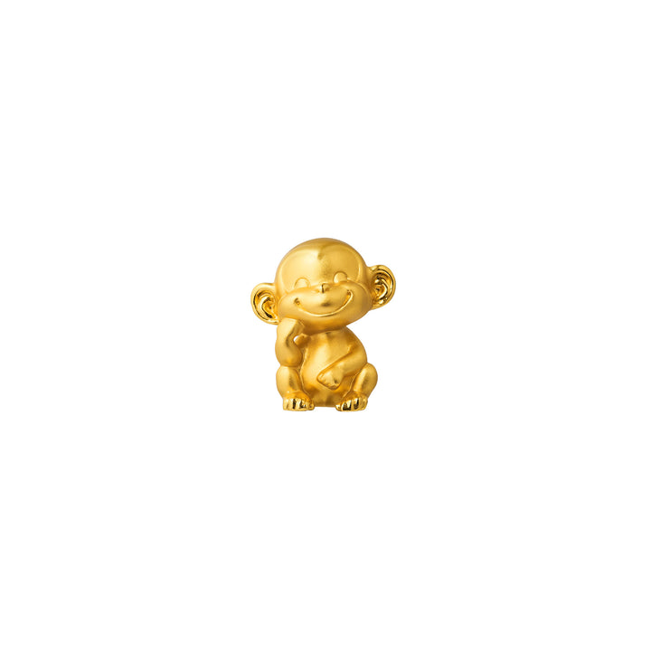 Gold-tone monkey figurine with raised arms and smiling face