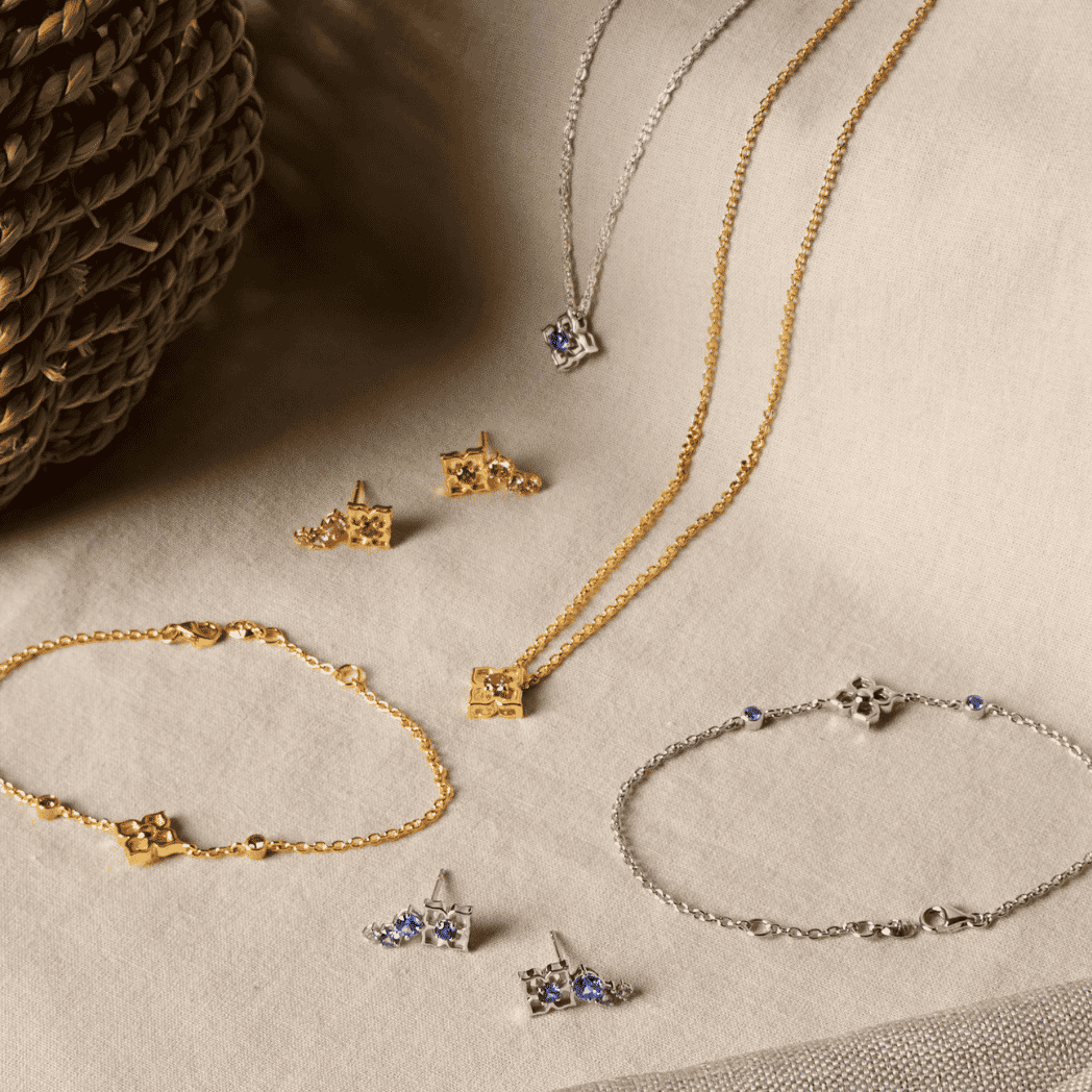 Rhodium silver bracelet with small blue sapphire star charms and toggle clasp