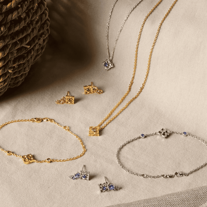 Rhodium silver bracelet with small blue sapphire star charms and toggle clasp