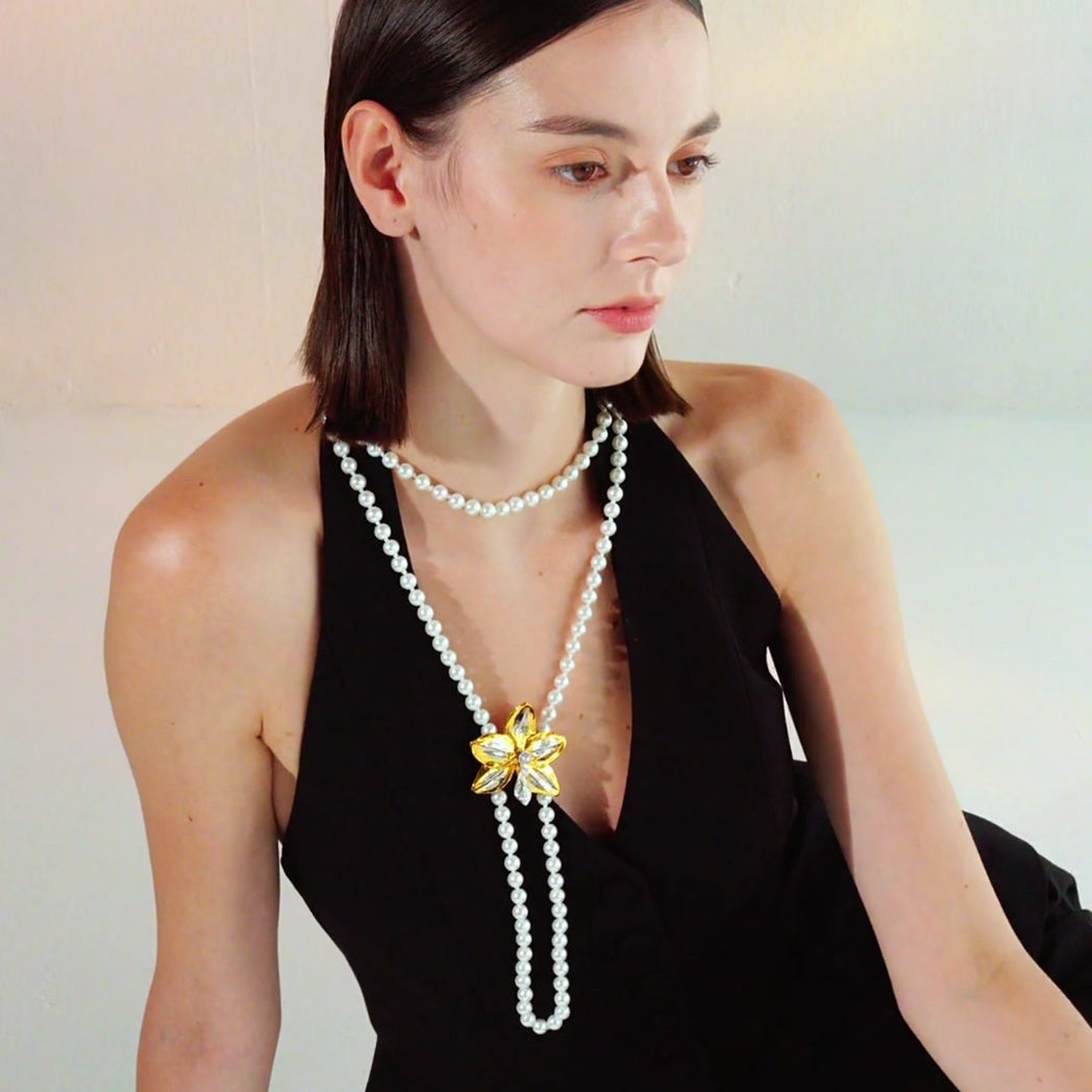 Three-strand pearl necklace with gold orchid pendant and diamond accents