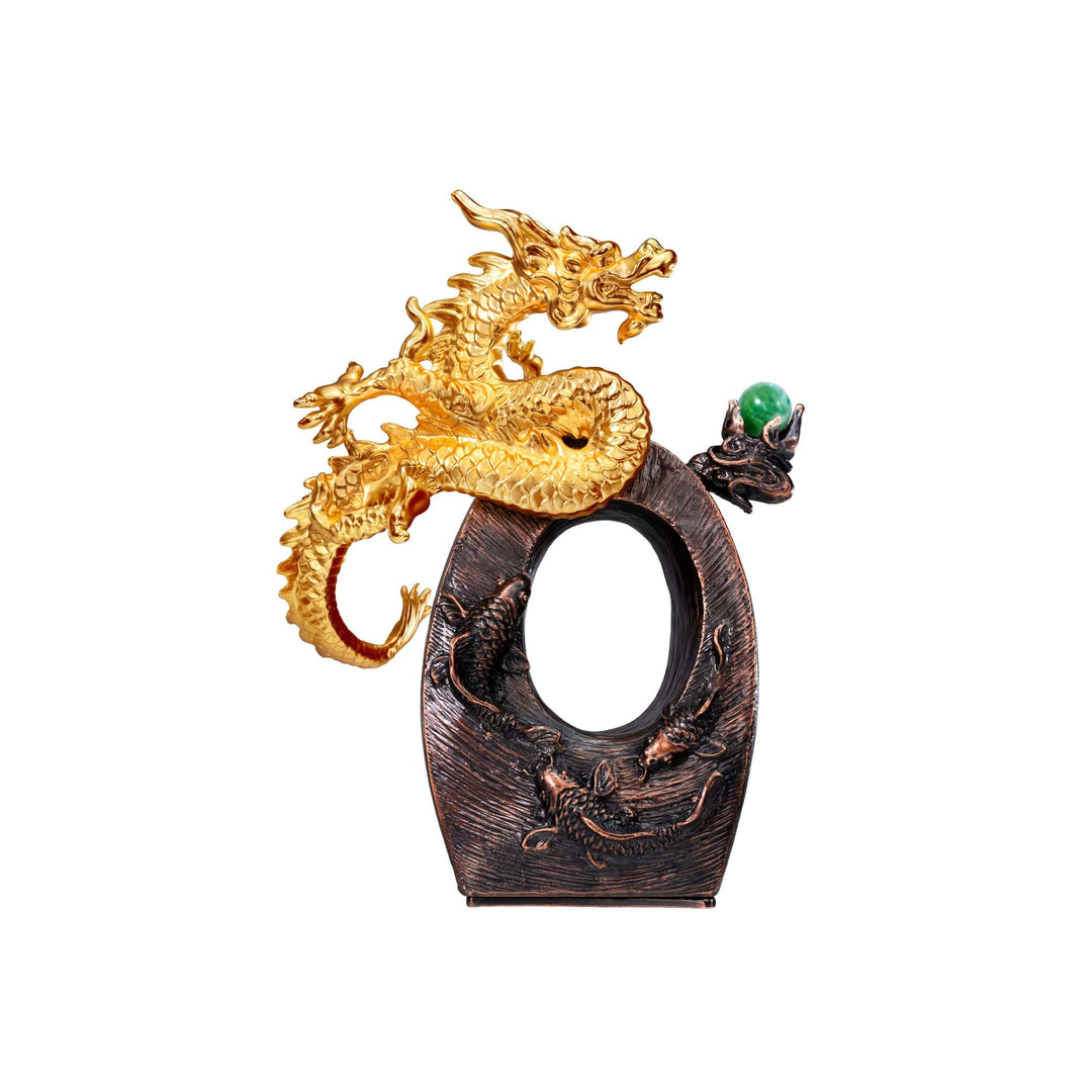 Risis Ascension Seal - This is an ornate, golden dragon with intricate scales and an aggressive posture, clutching a green orb, set against a dark, carved backdrop reminiscent of waves or flames.