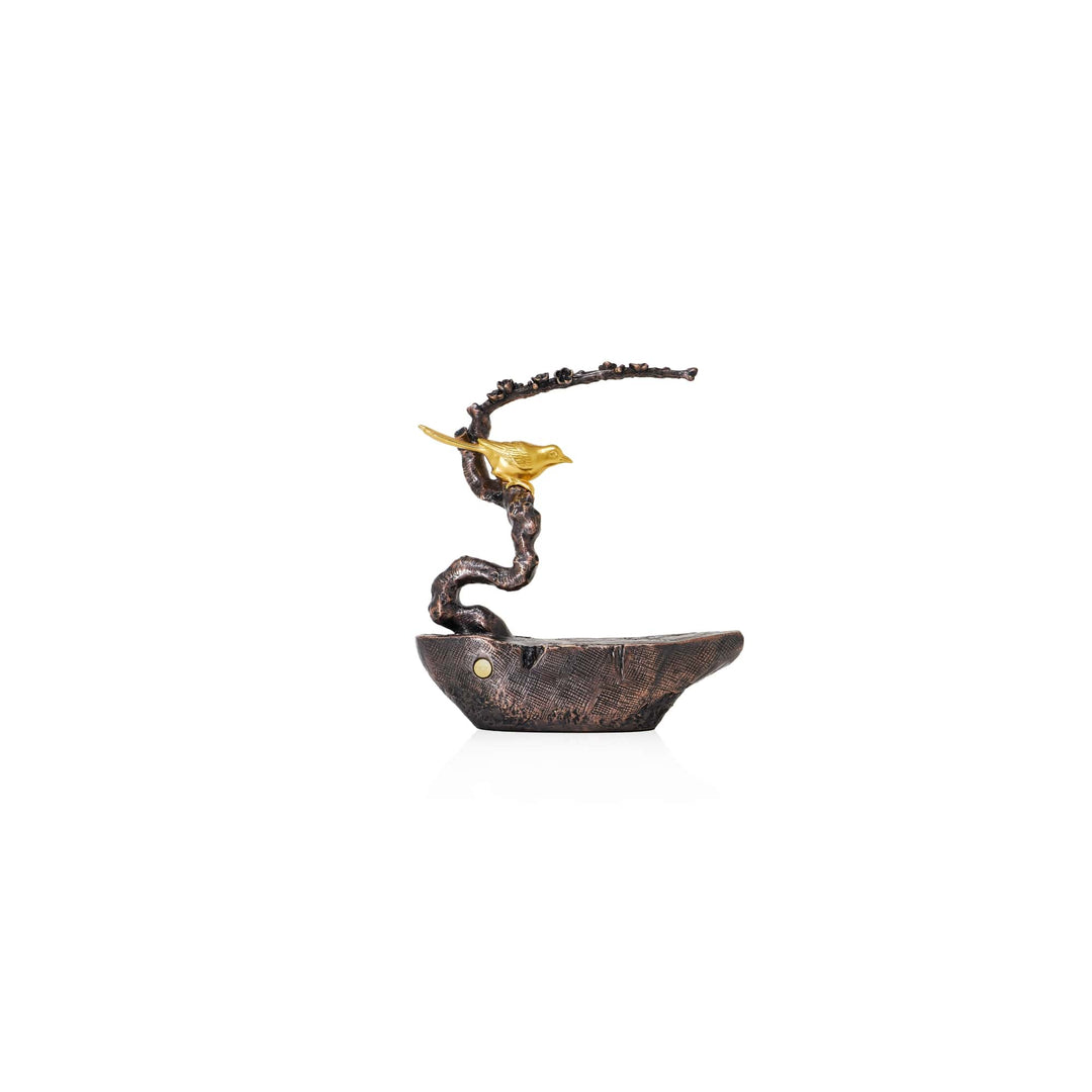 Risis Auspicious Magpie on Plum Blossom Branch - A twisted, bronze-colored sculptural piece serves as a stem rising from a textured vessel, culminating in a delicate, gold-colored leaf that unfurls gracefully at its apex.