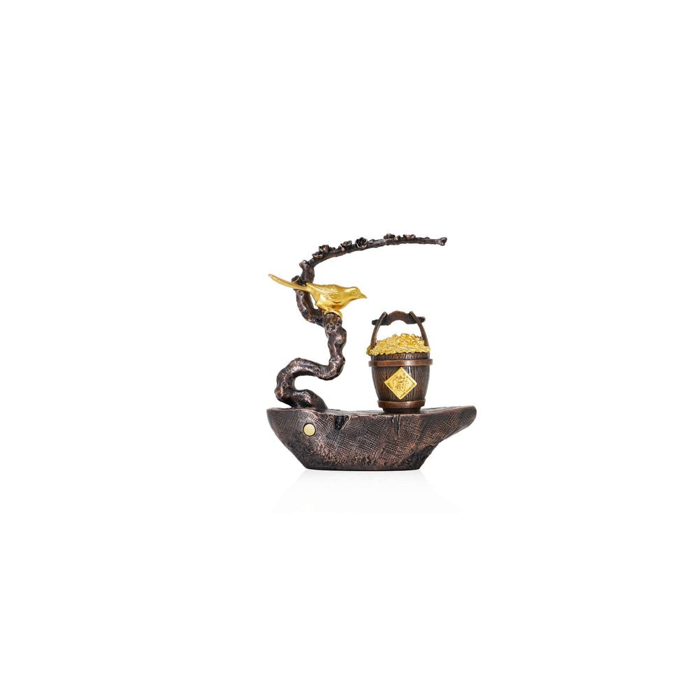 Risis Auspicious Magpie on Plum Blossom Branch - A bronze-colored sculpture depicts a stylized boat with a textured surface, carrying a golden basket. Above it, a branch with golden leaves spirals elegantly.