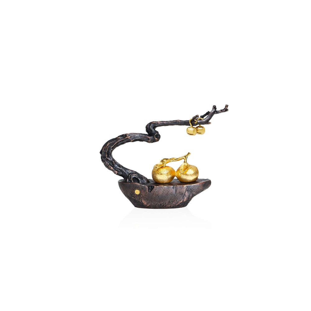 Risis Auspicious Persimmon Tree - A sculptural jewelry piece featuring a dark bronze branch-like structure that artistically arcs to hold two golden pear-shaped ornaments, all settled in a similarly styled boat-shaped base.