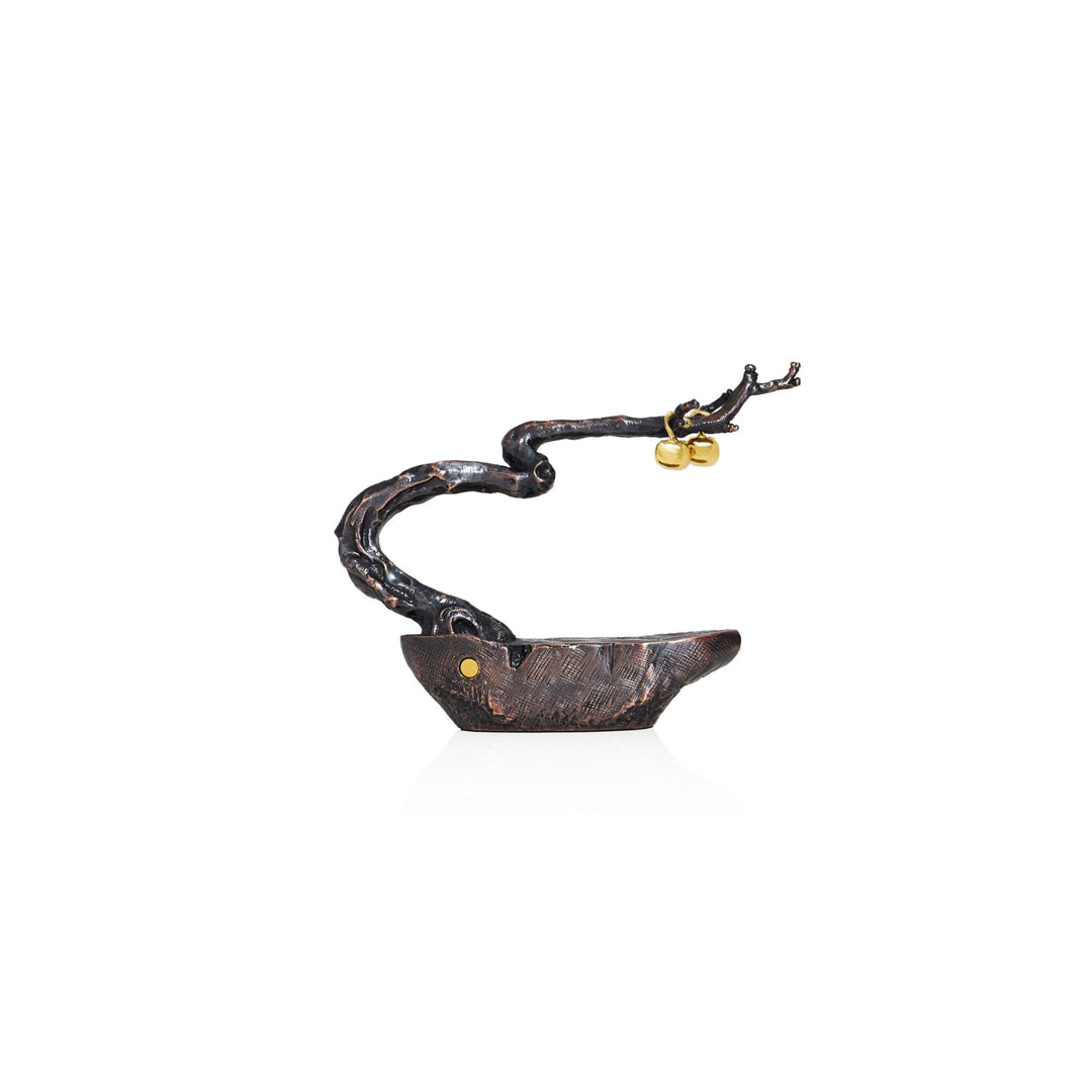 Risis Auspicious Persimmon Tree - A sculptural black pendant with textured detail and a golden accent, attached to a twisted, organic-looking chain with a golden clasp.