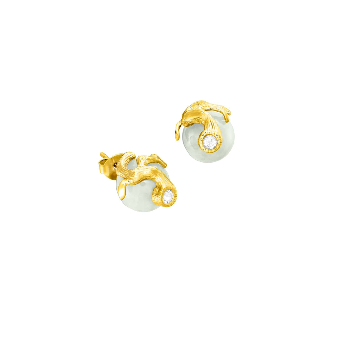 Risis Banyan Vines Jade Earrings - A pair of golden earrings with intricate, dolphin-shaped clasps holding circular, semi-opaque stones encircled by tiny sparkling gems.