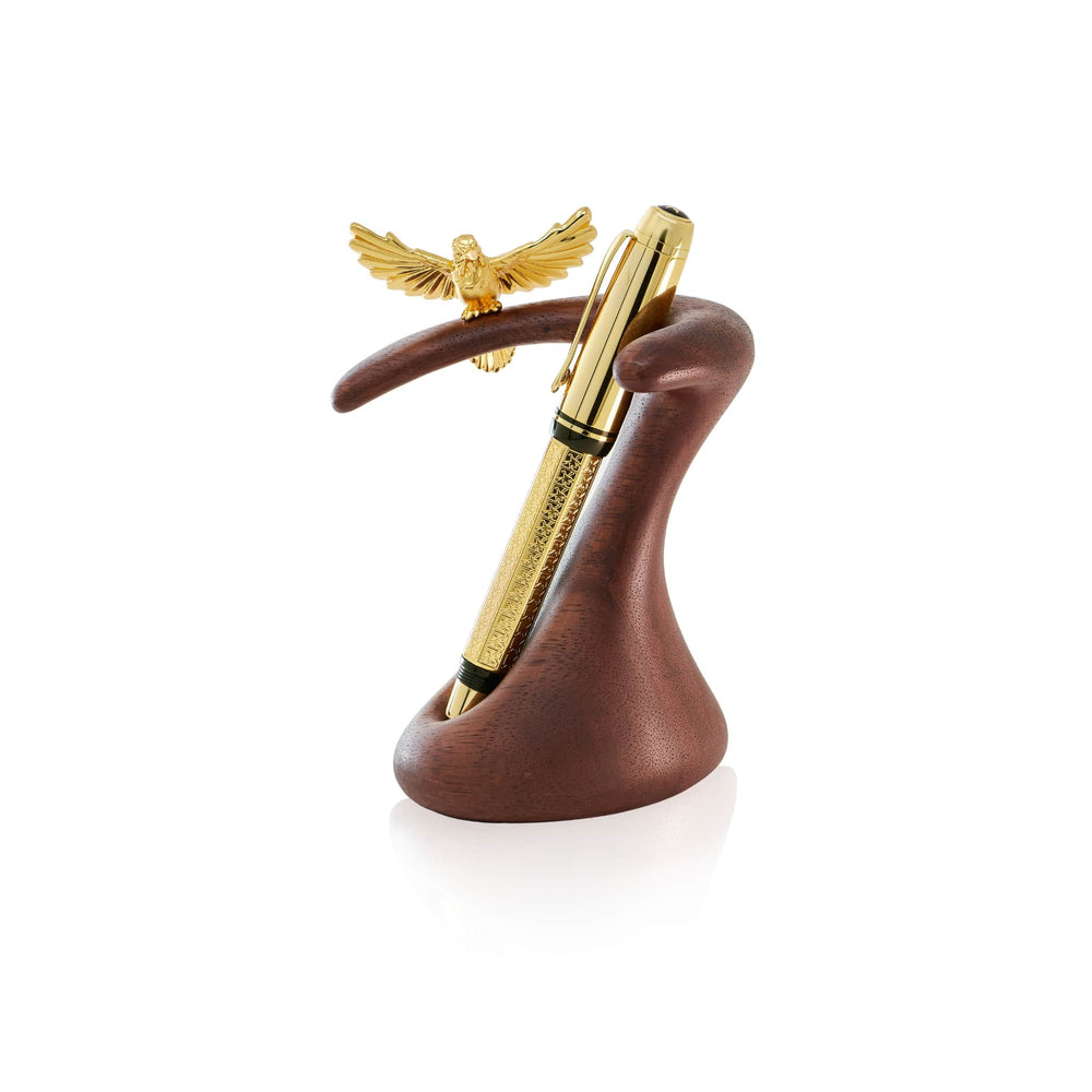 Risis Crimson Sunbird Pen Holder - The image features an elegant pen with a golden finish and detailed texturing cradled by a stylized wooden holder shaped like a swan, topped by an ornate golden eagle figurine.