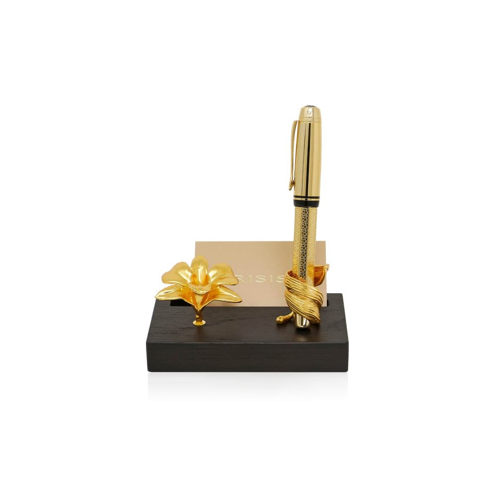Risis Dendrobium Tay Swee Keng Orchid Pen and Name Card Holder - A golden pen with intricate patterns stands upright, nestled in a twisted holder. Beside it rests a delicate, gold-toned orchid on a sleek black stand.