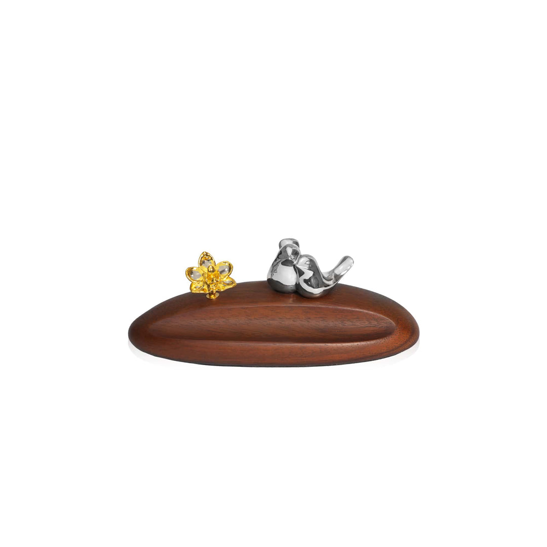 Risis Doritaenopsis Love Bird Pen Holder - A glossy wooden oval stand displays a shiny metallic bird figure next to a radiant yellow crystal flower, exemplifying intricate craftsmanship and design.