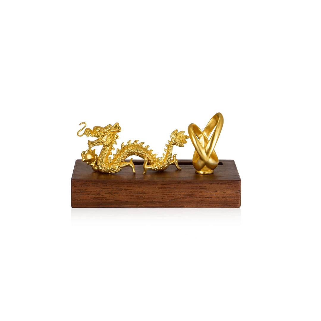 Risis Dragon Infinity Pen And Name Card Holder - A golden dragon and an abstract sculpture rest on a wooden base; the dragon is intricate and dynamic, while the sculpture is smooth and curvilinear.