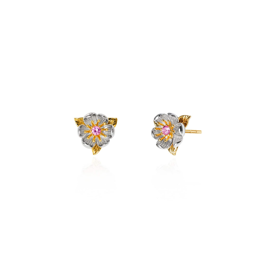 Risis Magnolia Blossom Earrings - A pair of earrings shaped like flowers with gold accents and silver petals, centered with pink and yellow gems, glisten symmetrically displayed.