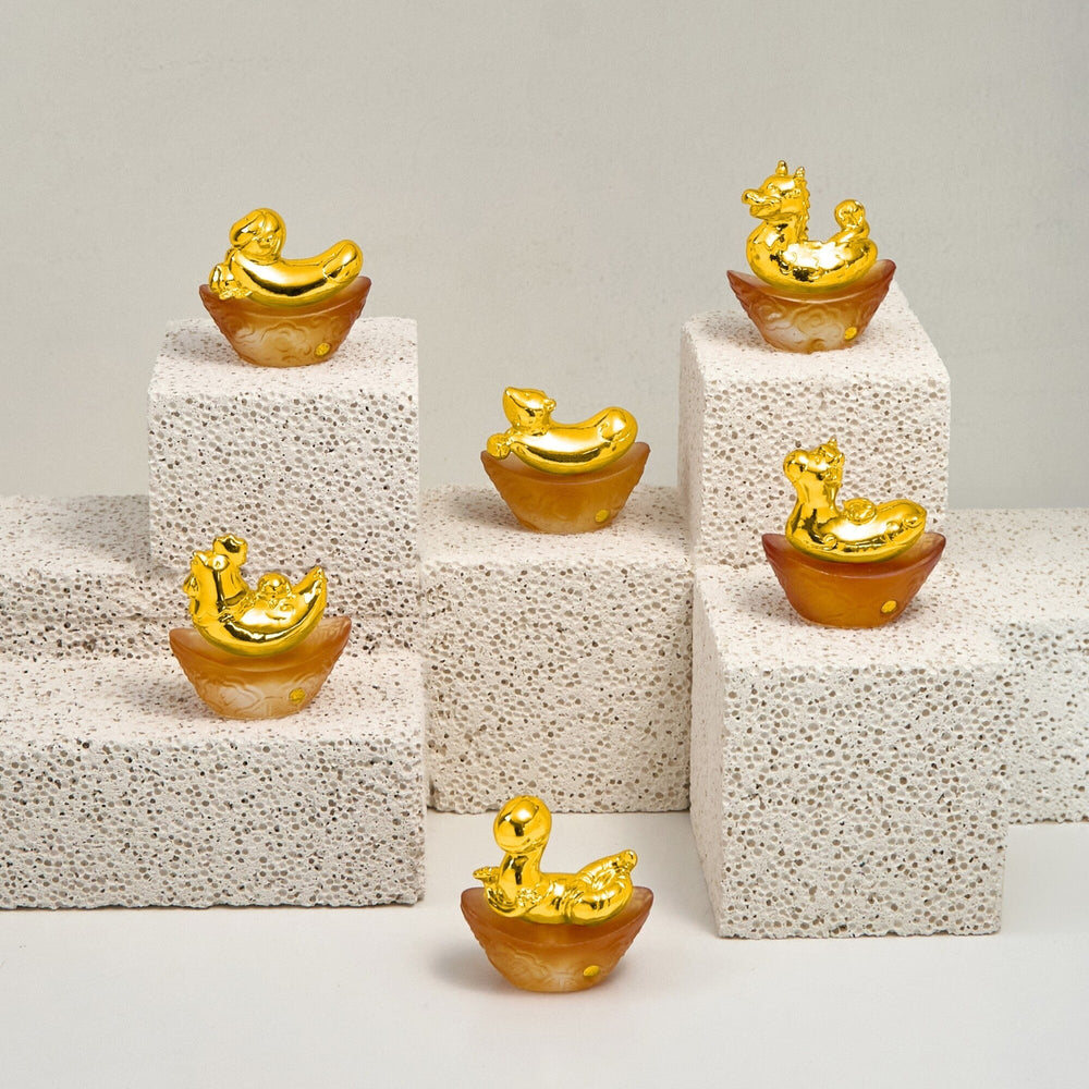Risis Mini Celestial – Monkey on Amber Liu Li - Six golden ingot-shaped ornaments with animated, smiling mouse figures atop are arranged at various heights on white, porous plinths, showcasing luster and whimsy.