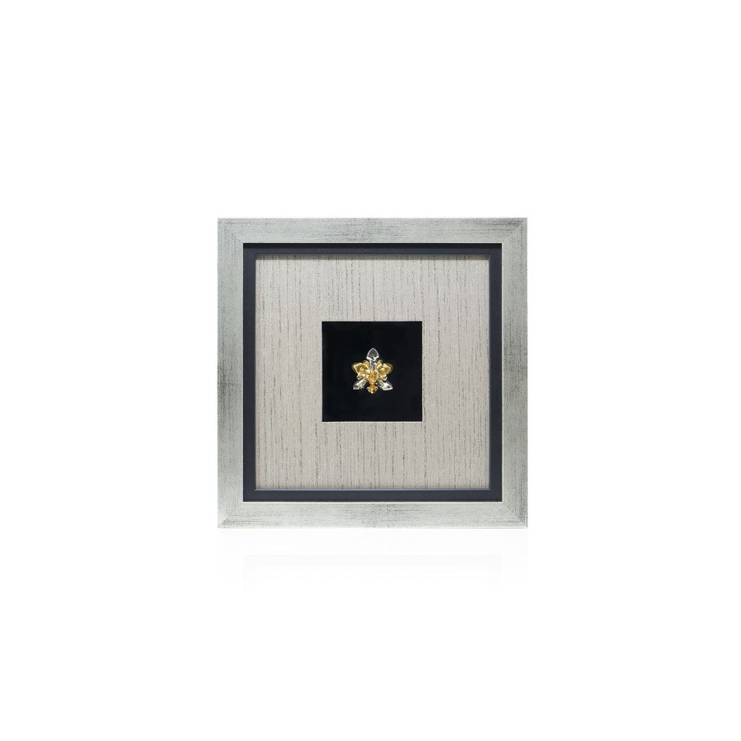 Risis Phalaenopsis Cross Orchid Frame - An ornate golden brooch with gemstones, presented centrally within a textured silver frame.