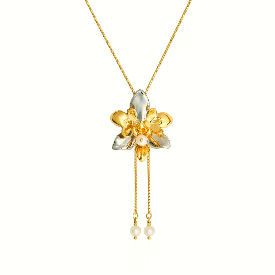 Risis Phalaenopsis Cross Orchid Slider with Pearl Tailends - A gold and silver floral pendant with shimmering petals, accented by a central pearl and two dangling pearls on fine chains.