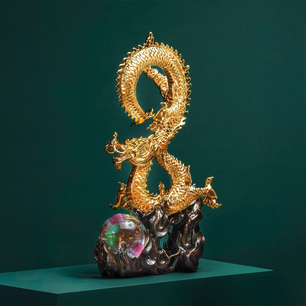 Risis Success Dragon II - A golden dragon sculpture coils around a glossy, multicolored orb, set on a dark, textured base, conveying regal and mystical qualities through its intricate details and shimmering surface.