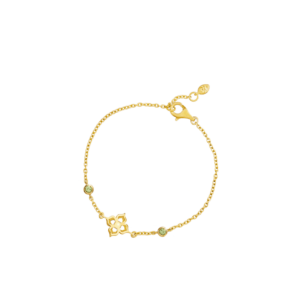 Risis Timeless Peranakan Bracelet With Peridot - A golden bracelet with a delicate chain, featuring a central geometric motif and two small green gemstones, set in a simple yet elegant design.