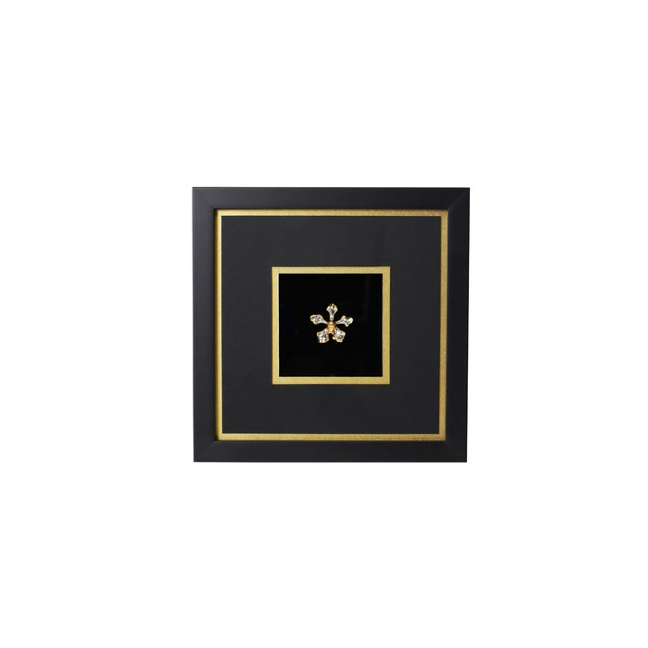Risis Vanda Wee Kim Lian Orchid Frame IV - A golden, starburst-shaped brooch with gemstone accents is centrally displayed against a black, square backdrop framed in black with gold trim.