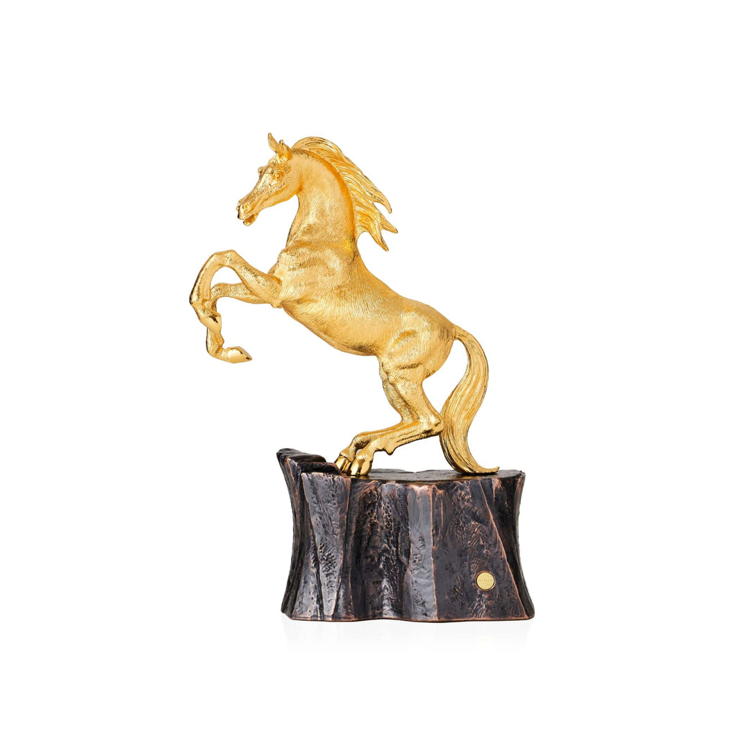 Risis Victory Horse III - A golden sculpture of a rearing horse, with intricate details and a lustrous finish, is perched atop a glossy, dark rectangular base.