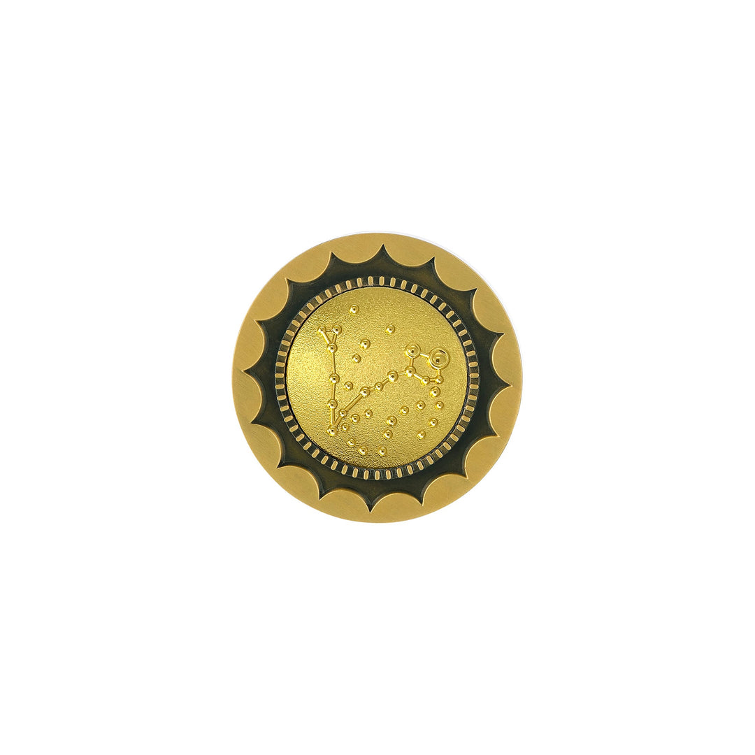 Risis 12 Constellation Base (Pisces) - A circular golden brooch with a textured, scalloped edge and a smooth, embossed center featuring a constellation design.