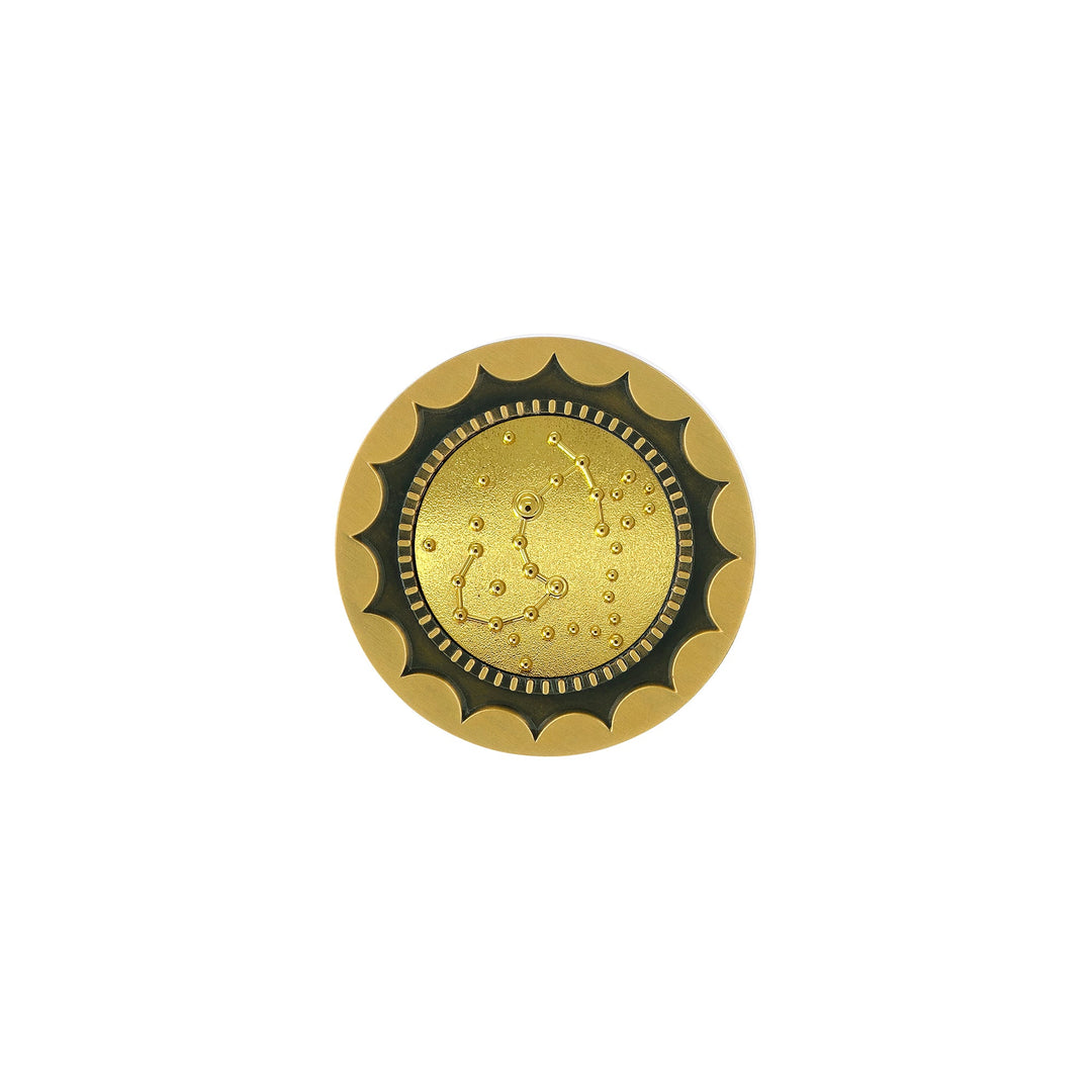 Risis 12 Constellation Base (Scorpio) - A round, golden-colored brooch with a scalloped edge and a textured, dotted center resembling an intricate constellation.