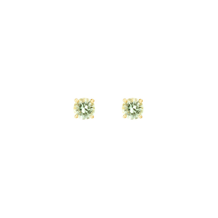 Risis Midori Earrings With Prasiolite - A pair of round-cut, light green gemstone earrings with a golden setting, reflecting light with a subtle sparkle.