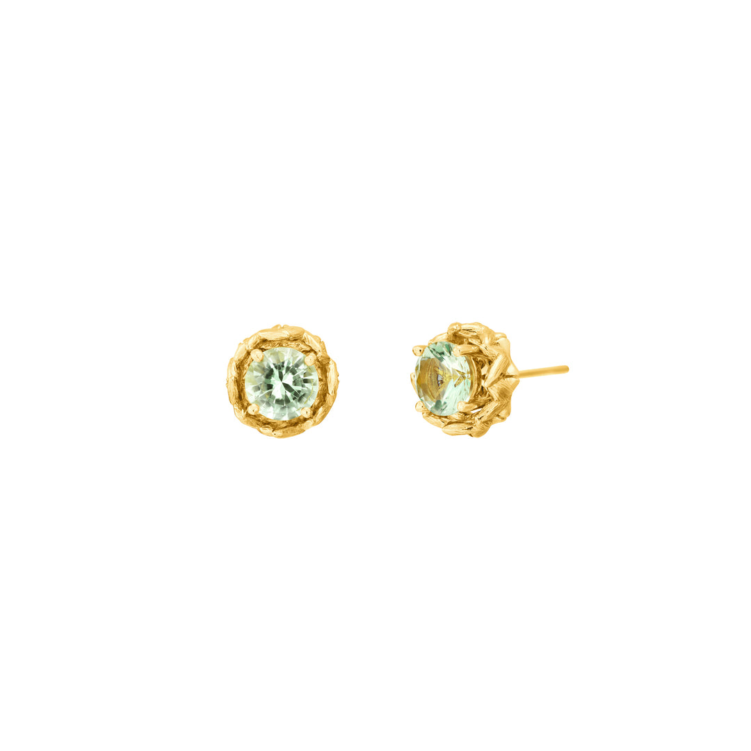 Risis Midori Earrings With Prasiolite - A pair of gold earrings each featuring a central pale green gemstone, encased in a textured, golden flower-like setting.