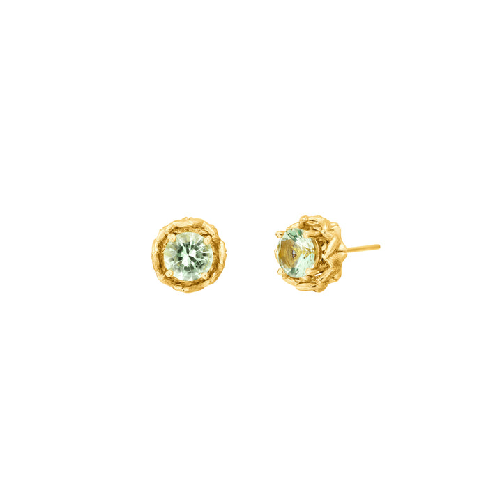 Risis Midori Earrings With Prasiolite - A pair of gold earrings each featuring a central pale green gemstone, encased in a textured, golden flower-like setting.