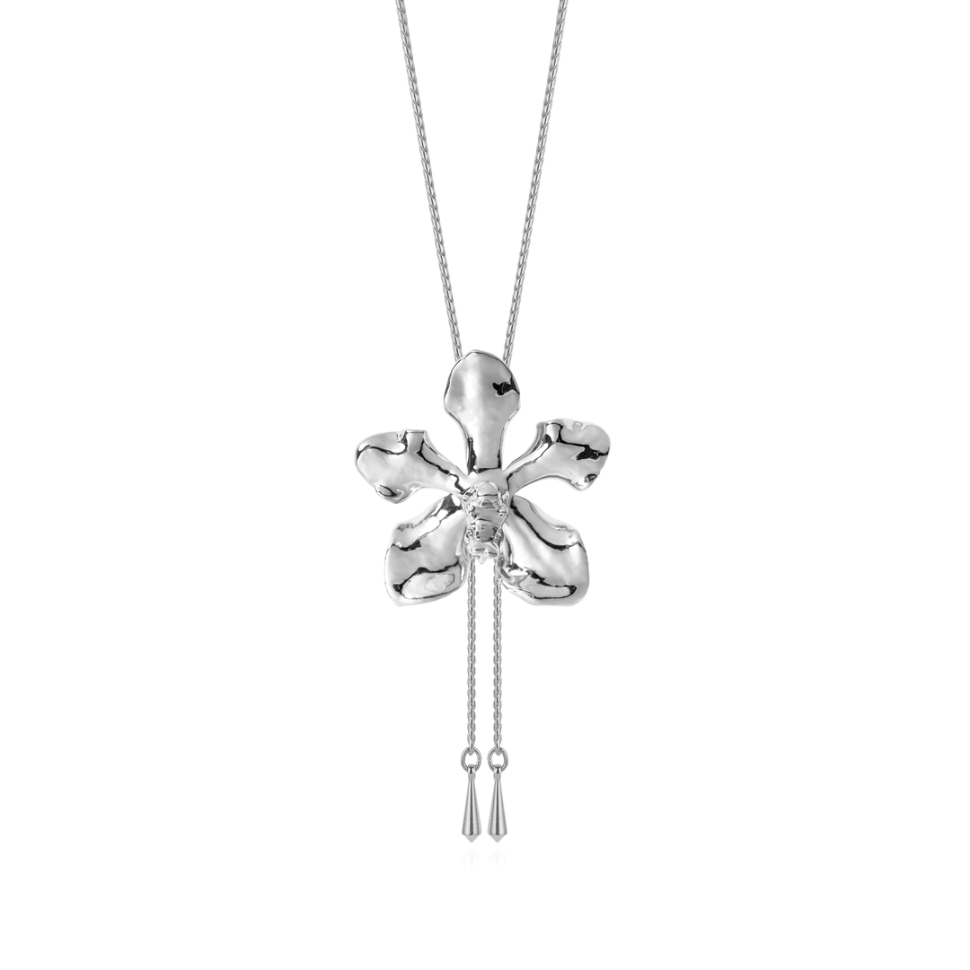 Risis Vanda Limbata Orchid Slider P - A polished silver orchid pendant with an organic, asymmetrical design hangs on a chain, featuring delicate tassels dangling from the flower's center.