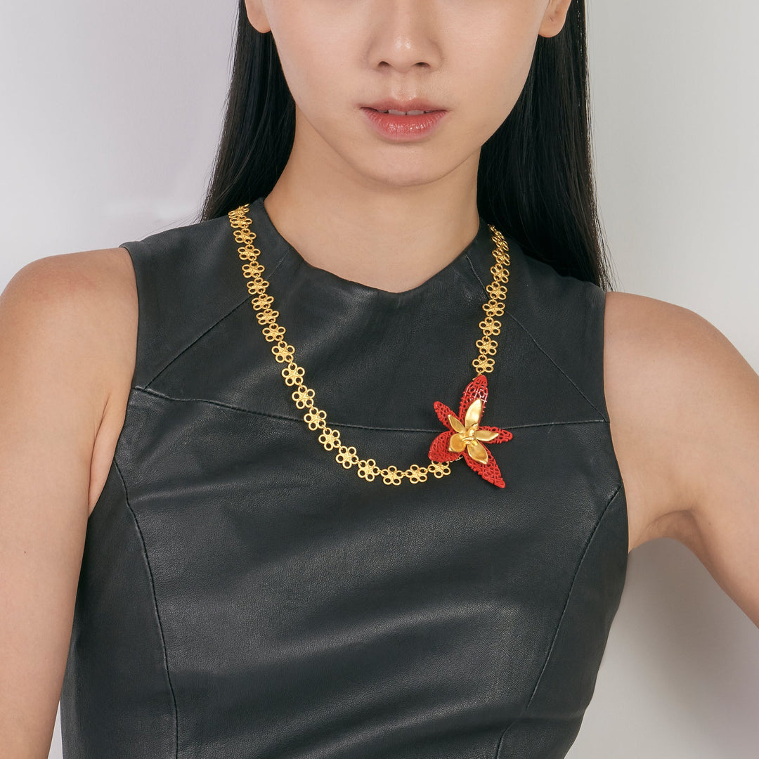 RISIS X TRIOLOGIE Iconic Phalaenopsis Orchid Necklace on model 1