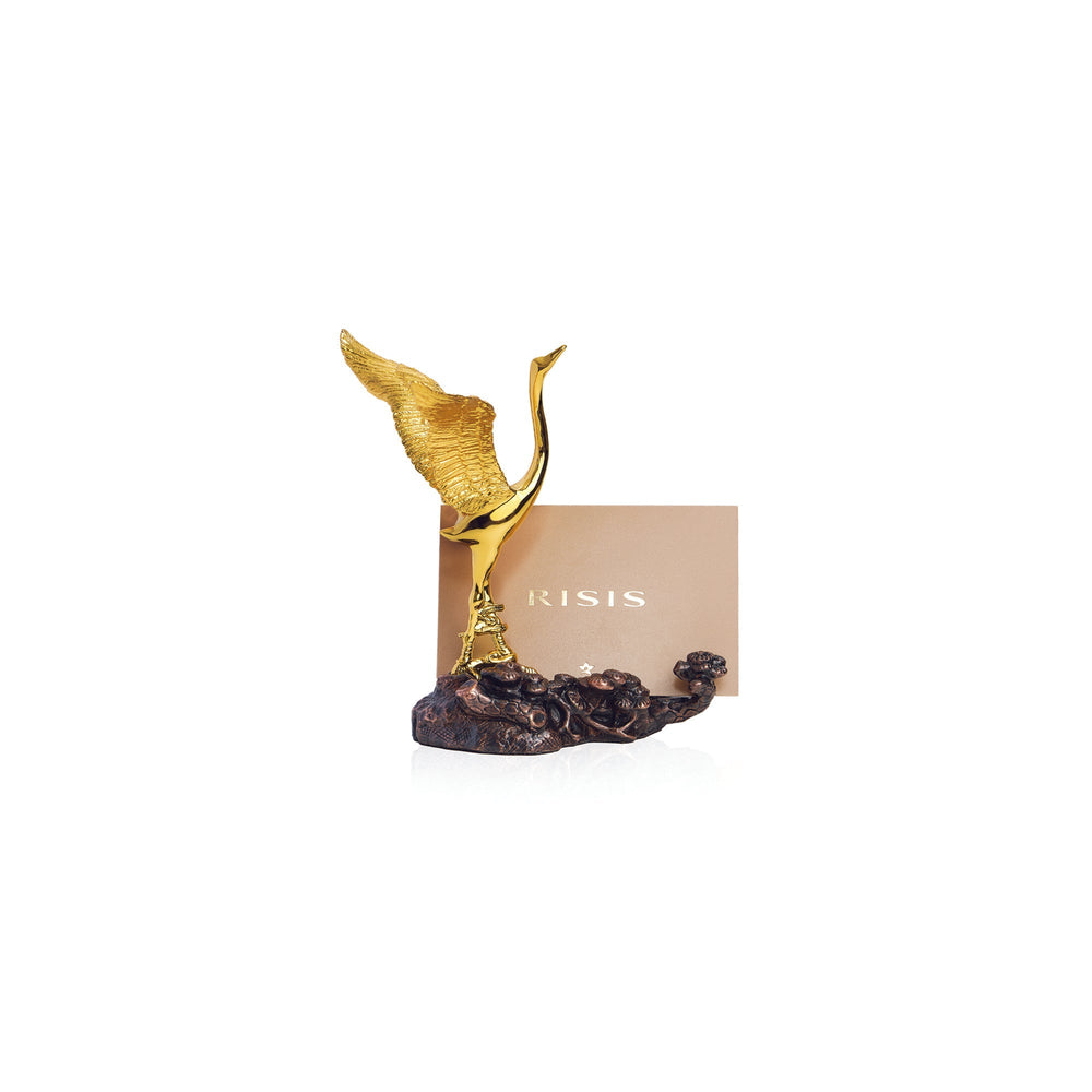 Risis Auspicious Crane on Pine - A golden orchid blooms from a textured, dark base, an artistic ornament displaying elegance and contrast in color and texture.