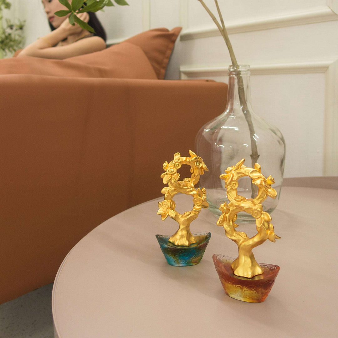 Risis Auspicious Money Tree with Bronze Liu Li Base - Two ornate golden trees with floral motifs sit in colorful, translucent pots, displayed on a table.