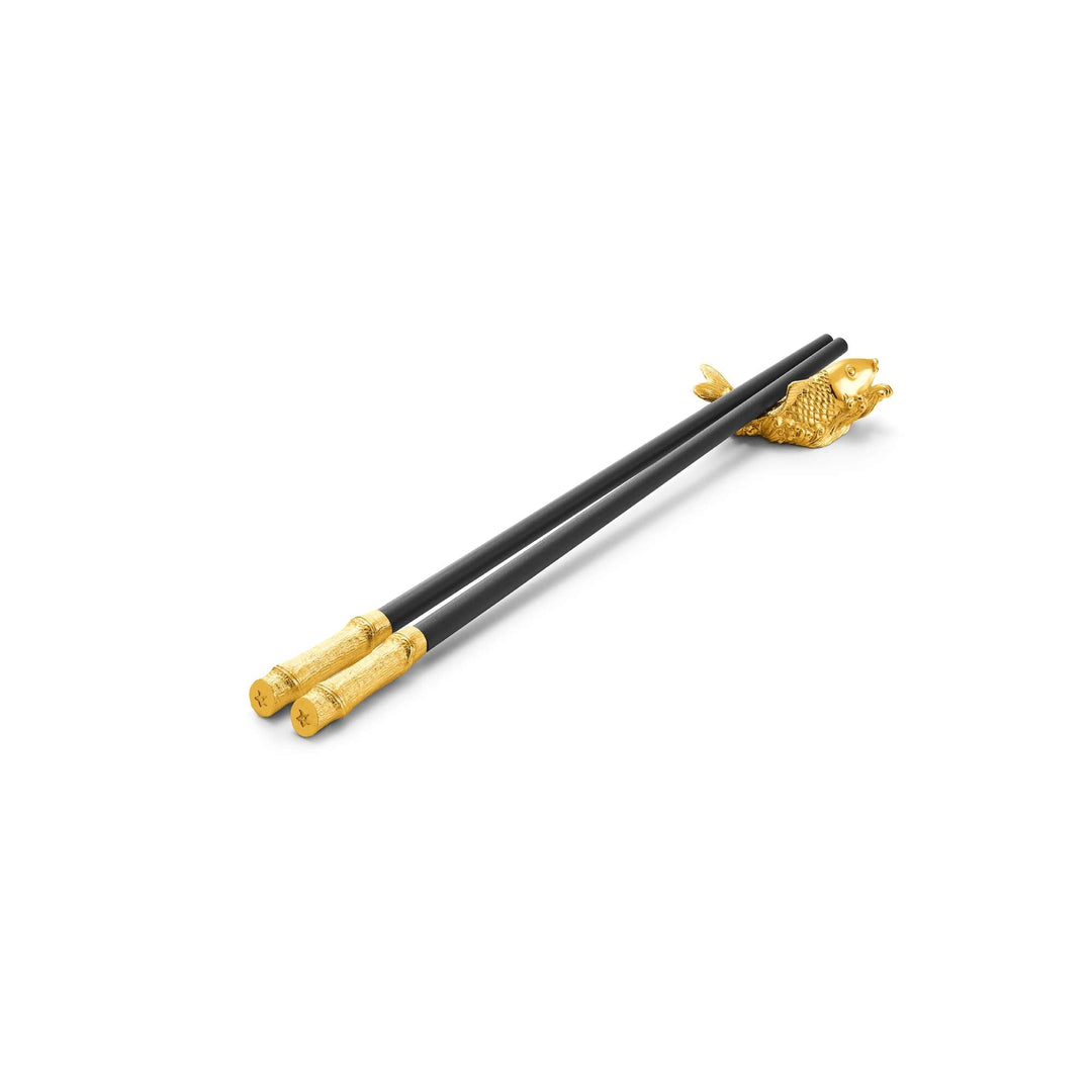 Risis Chopsticks with Carp Rest - A pair of elegant chopsticks with black slender stems and ornate golden ends, featuring a textured fish design where they rest on the surface.