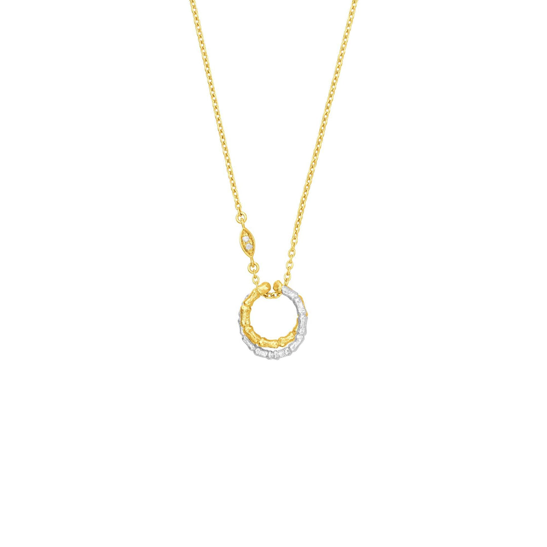 Risis Bamboo Twist Necklace with White Sapphires - A two-tone circular pendant hangs from a delicate gold chain, half embellished with sparkling clear gemstones, and half with textured gold detailing.