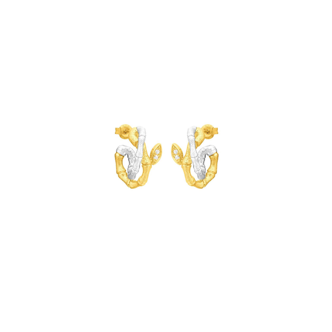 Risis Bamboo Twist Pierced Earrings with White Sapphires - A pair of earrings with an abstract design, featuring textured gold and smooth silver elements, accented with small, clear gemstones.